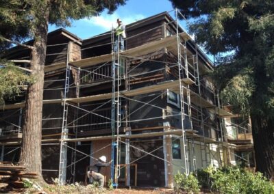 a person standing on scaffolding next to a building