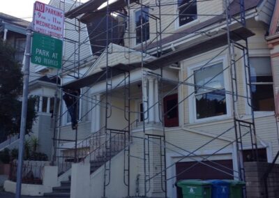 a building with scaffolding and a sign